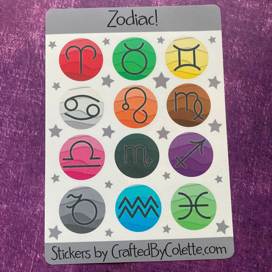 A sheet of stickers titled "Zodiac Stickers (Copy)" features 12 circular icons, each representing a zodiac sign. The icons are colored in various shades like red, green, and blue. The sheet includes the website address "CraftedByColette.com" at the bottom. The background is purple and it is branded by Crafted By Colette.